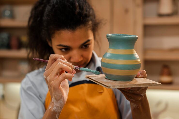 medium-shot-woman-painting-pot_23-2148944904